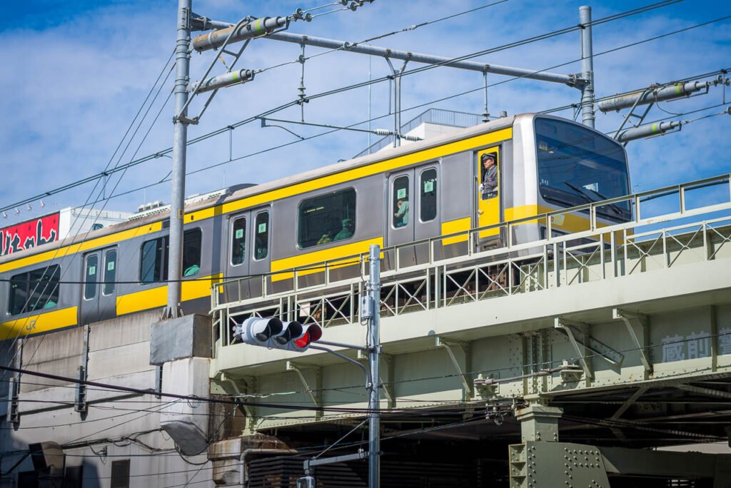 Train in Tokyo passing over a bridge.