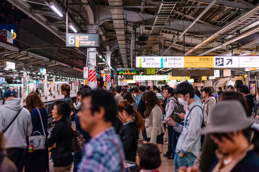 People waiting for a train in a Tokyo subway station.