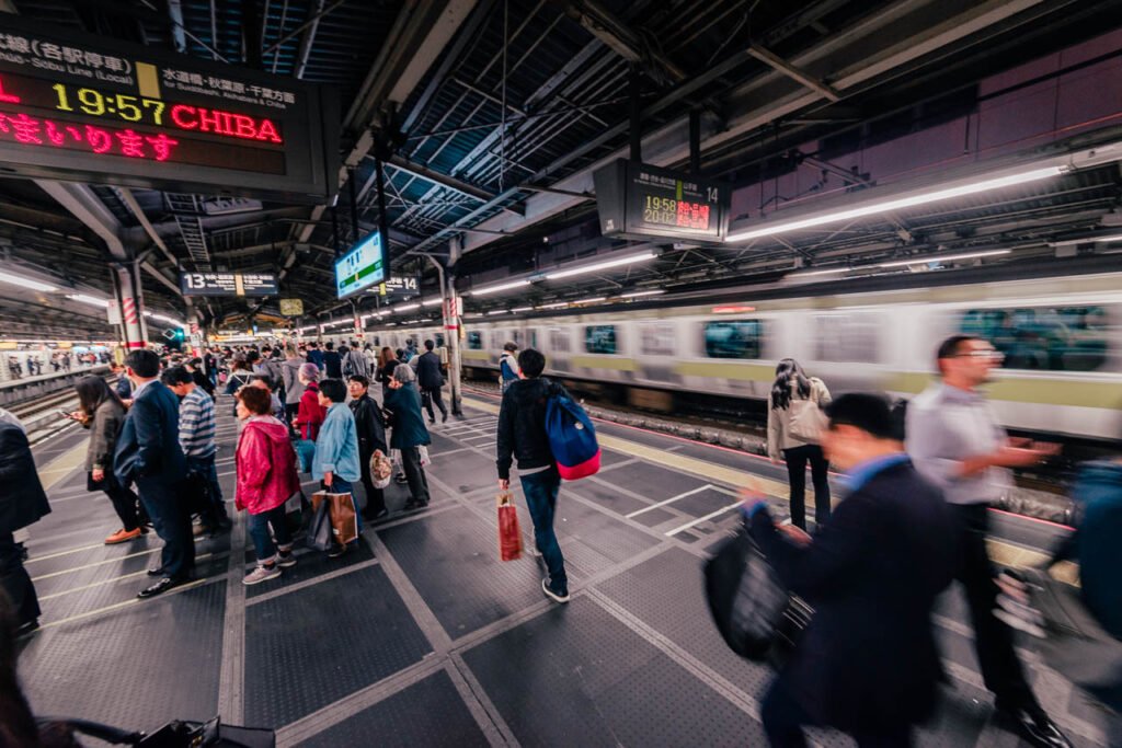 People on a station platform in a Tokyo subway station.